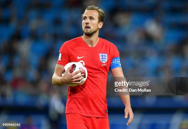 Harry Kane of England holds the match ball as he waits to take the penalty from which he scores the opening goal during the 2018 FIFA World Cup...