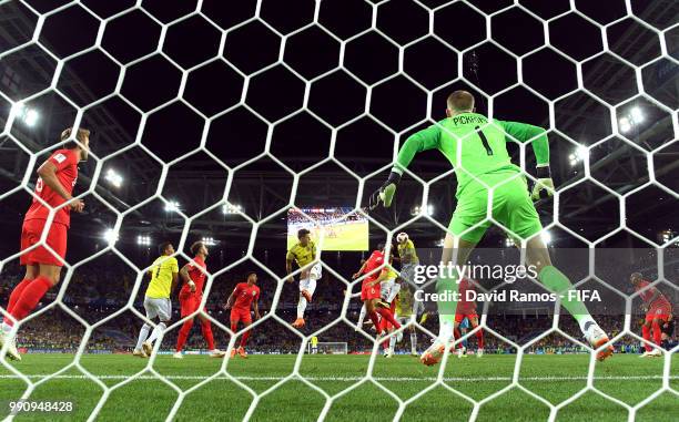 Yerry Mina of Colombia scores past Jordan Pickford of England his team's first goal during the 2018 FIFA World Cup Russia Round of 16 match between...