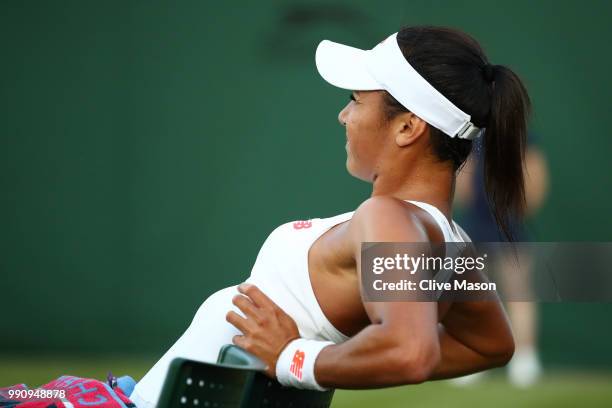 Heather Watson of Great Britain stretches after her Ladies' Singles first round match against Kirsten Flipkens of Belgium on day two of the Wimbledon...