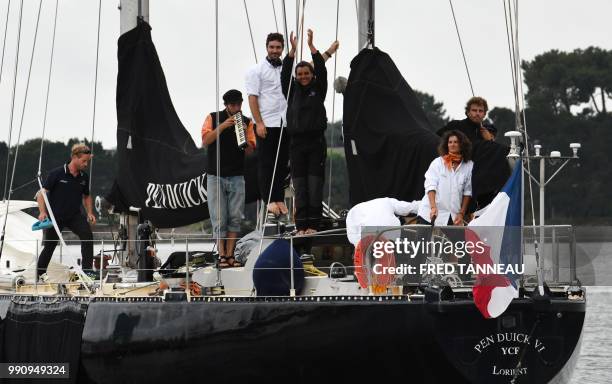 French skipper Marie Tabarly and her team stand on the deck of the Pen-Duick VI as they leave the port of Lorient for her sailing project...