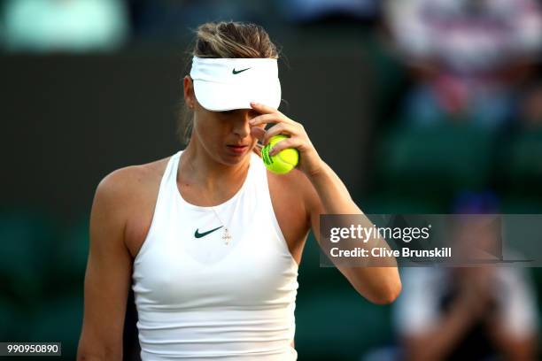 Maria Sharapova of Russia looks on during her Ladies' Singles first round match against Vitalia Diatchenko of Russia on day two of the Wimbledon Lawn...