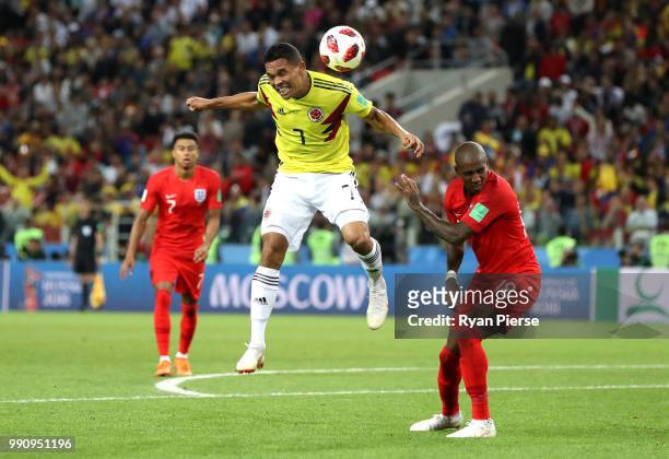 Carlos Bacca of Colombia wins a header from Ashley Young of England during the 2018 FIFA World Cup Russia Round of 16 match between Colombia and...