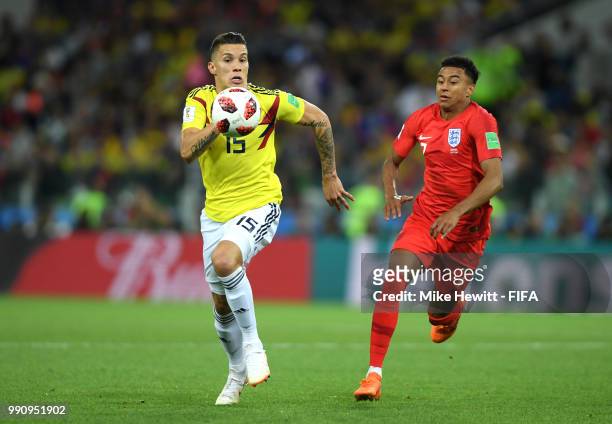 Mateus Uribe of Colombia and Jesse Lingard of England chase after the ball during the 2018 FIFA World Cup Russia Round of 16 match between Colombia...