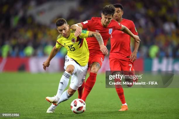 Mateus Uribe of Colombia is tackled by John Stones of England during the 2018 FIFA World Cup Russia Round of 16 match between Colombia and England at...