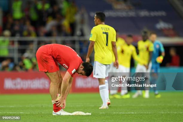 Harry Maguire of England adjusts his socks at end of the game before extra time during the 2018 FIFA World Cup Russia Round of 16 match between...