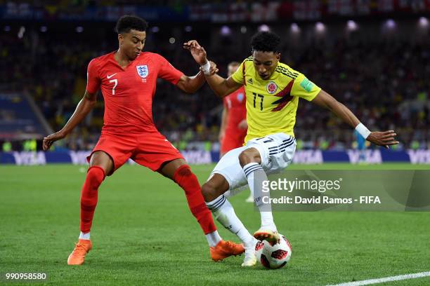 Johan Mojica of Colombia is challenged by Jesse Lingard of England during the 2018 FIFA World Cup Russia Round of 16 match between Colombia and...