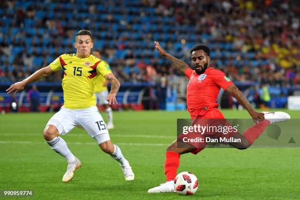 Danny Rose of England shoots just wide under pressure from Mateus Uribe of Colombia during the 2018 FIFA World Cup Russia Round of 16 match between...