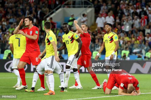 Eric Dier and Harry Maguire of England react during the 2018 FIFA World Cup Russia Round of 16 match between Colombia and England at Spartak Stadium...