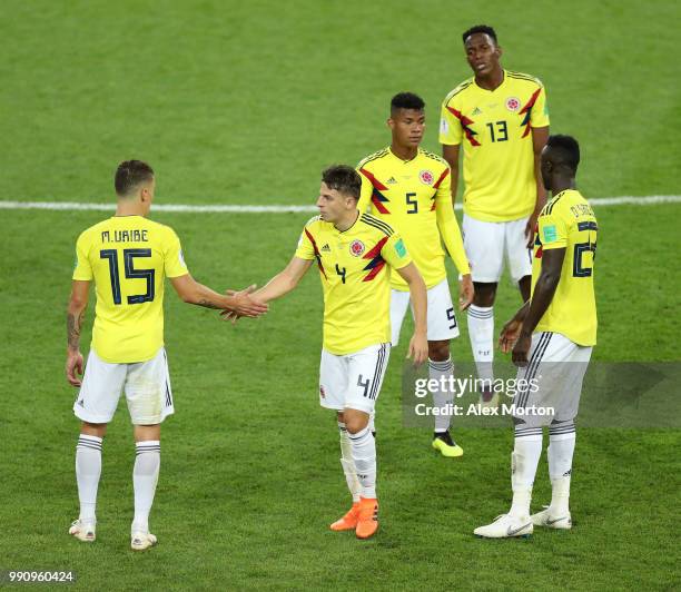 Santiago Arias of Colombia is congratulated by team mates before being replaced during the 2018 FIFA World Cup Russia Round of 16 match between...