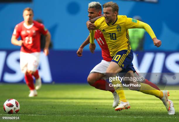 Valon Behrami of the Switzerland national football team and Emil Forsberg of the Sweden national football team vie for the ball during the 2018 FIFA...