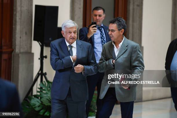 Mexican President-elect Andres Manuel Lopez Obrador , talks with his future General Coordinator of Social Comunications, Cesar Yanez, after holding a...