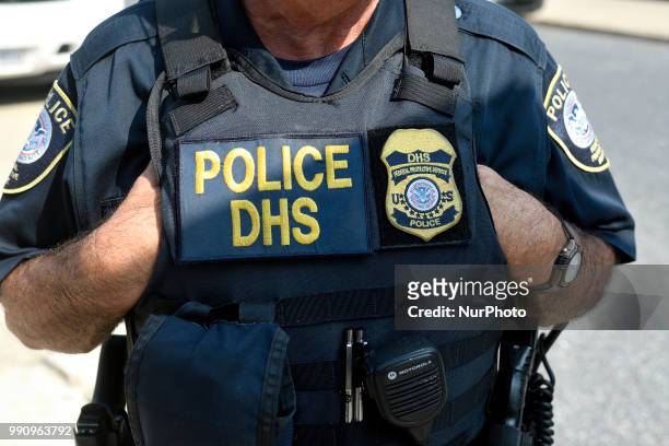Law enforcement officers of the Philadelphia Police Department, Homeland Security and National Park Service stands by as protestors build a small...