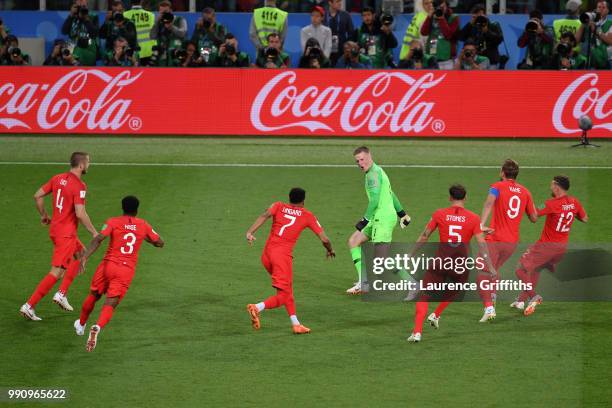 Jordan Pickford of England is celebrated by team mates during penalty shoot out during the 2018 FIFA World Cup Russia Round of 16 match between...