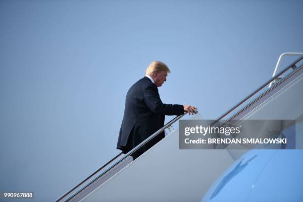 President Donald Trump boards Air Force One at Joint Base Andrews in Maryland as he travels to White Sulphur Springs, West Virginia, for a speech.