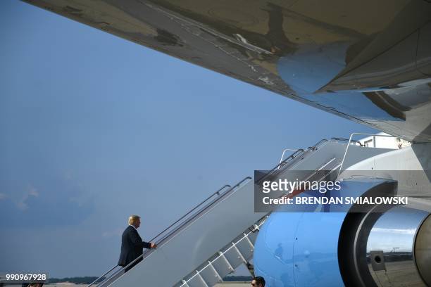 President Donald Trump boards Air Force One at Joint Base Andrews in Maryland as he travels to White Sulphur Springs, West Virginia, for a speech.