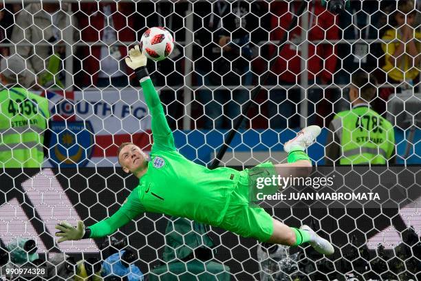 England's goalkeeper Jordan Pickford stops Colombia's forward Carlos Bacca's shot during the penalty shootout at the end of the Russia 2018 World Cup...