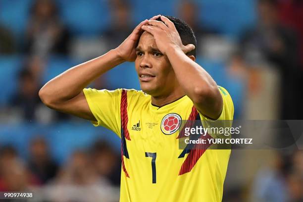 Colombia's forward Carlos Bacca reacts after failing to score in the penalty shootout during the Russia 2018 World Cup round of 16 football match...