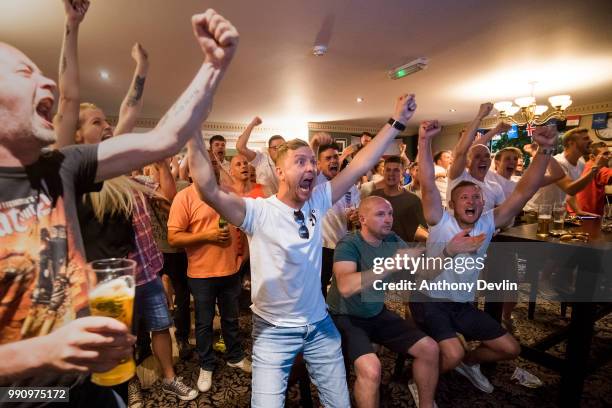 Fans celebrate as England win on penalties during the FIFA 2018 World Cup Finals match between Colombia and England at The Lord Stamford public house...