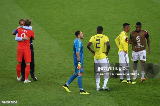 Gareth Southgate, Manager of England celebrates victory with Harry Kane as Colombia players walk off dejected following the 2018 FIFA World Cup...