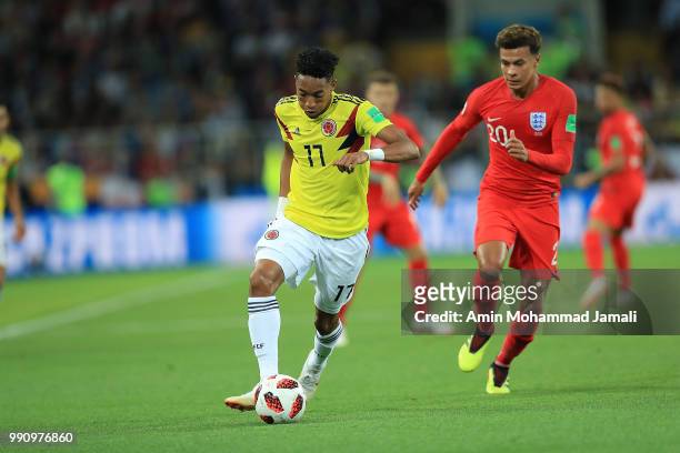 Juan Cuadrado of Colombia and Dele Alli of England compete for the ball during the 2018 FIFA World Cup Russia Round of 16 match between Colombia and...
