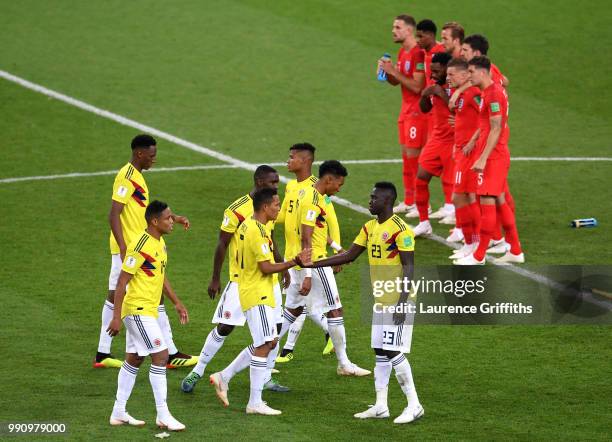 England and Colombia players look on from half way line during the penalty shoot out during the 2018 FIFA World Cup Russia Round of 16 match between...
