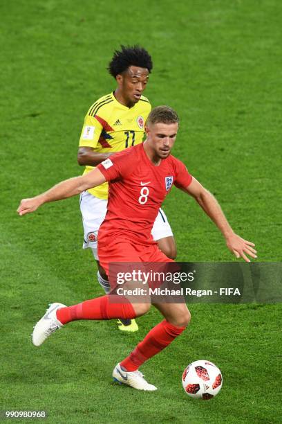 Jordan Henderson is challenged by Juan Cuadrado of Colombia during the 2018 FIFA World Cup Russia Round of 16 match between Colombia and England at...