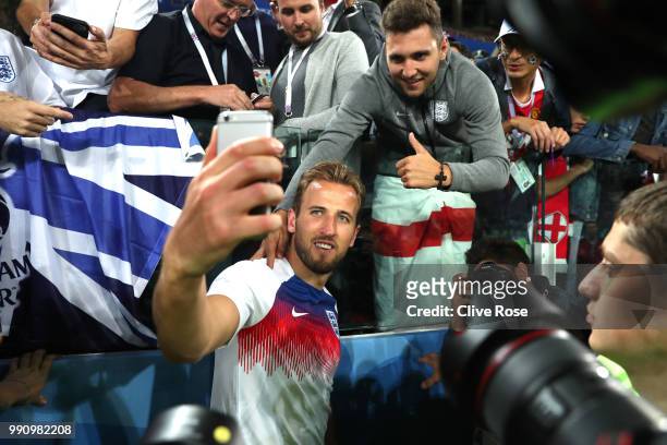 Harry Kane of England celebrates victory by taking selfie photogrpahs with fans after the 2018 FIFA World Cup Russia Round of 16 match between...