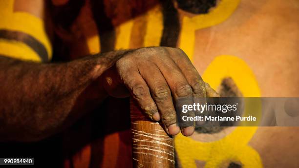 an aboriginal man's hand resting on a didgeridoo - fun northern territory stock pictures, royalty-free photos & images