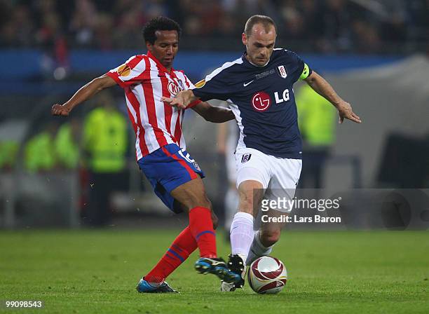 Danny Murphy of Fulham battles for the ball with Paulo Assuncao of Atletico Madrid during the UEFA Europa League final match between Atletico Madrid...