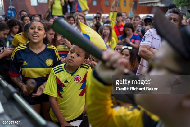 Colombian football fans living in London watch their team's eventual 4-3 loss with England in the knock-out stage of the World Cup at Elephant and...