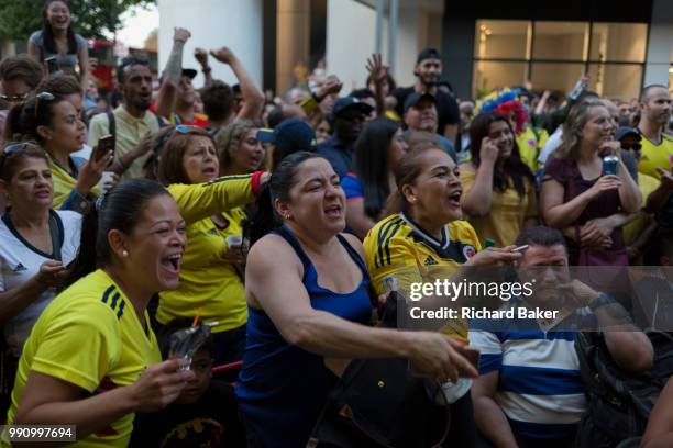 Colombian football fans living in London watch their team's eventual 4-3 loss with England in the knock-out stage of the World Cup at Elephant and...