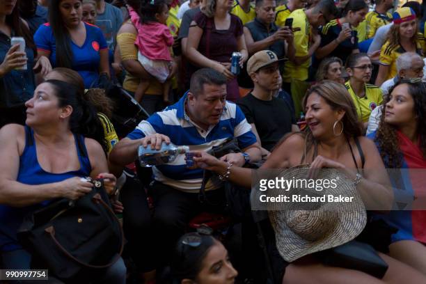 Colombian football fans living in London watch their team's eventual 4-3 loss with England in the knock-out stage of the World Cup at Elephant and...