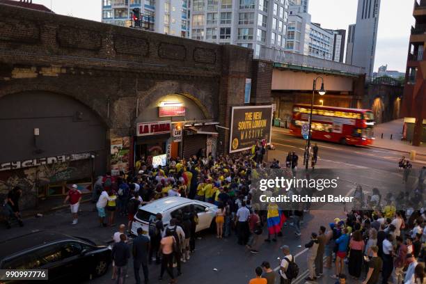 Colombian football fans living in London watch their team's eventual 4-3 loss with England in the knock-out stage of the World Cup at Elephant and...