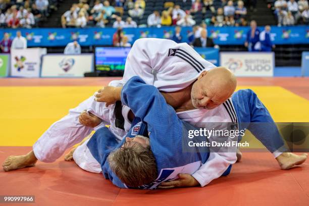 Volodymyr Ivanenko of Ukraine holds James Mckelvie of Great Britain to win the o100kg M7 bronze medal during day 1 of the 2018 Glasgow Veteran...