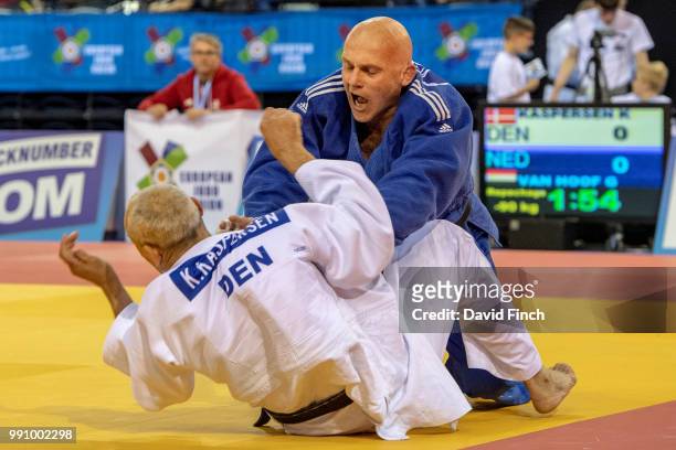 Genio Van Hoof of the Netherlands throws Karsten Kaspersen of Denmark for a wazari and later an ippon to win their u90kg M6 repechage contest during...
