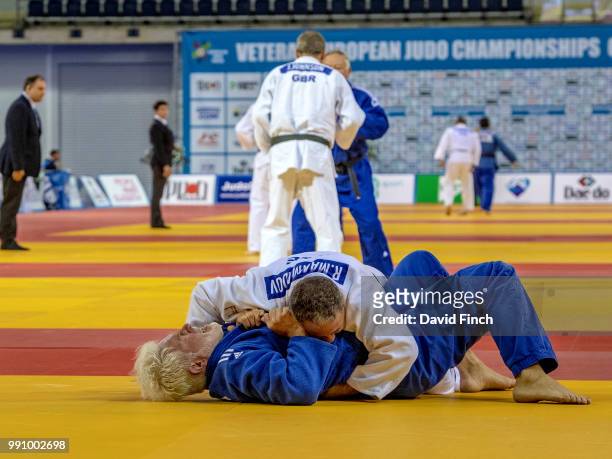 Ramiz Mammadov of Azerbaijan holds Berend Jan Kroesen of the Netherlands for an ippon to win their u100kg M6 repechage contest during day 1 of the...