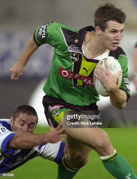 Clinton Schifcofske of the Raiders breaks the tackle of Craig Polla-Mounter of the Bulldogs during the round 15 NRL match between the Bulldogs and...