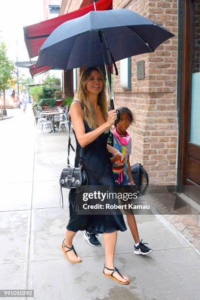Heidi Klum and daughter Lou seen out on a rainy evening in Manhattan on July 3, 2018 in New York City.