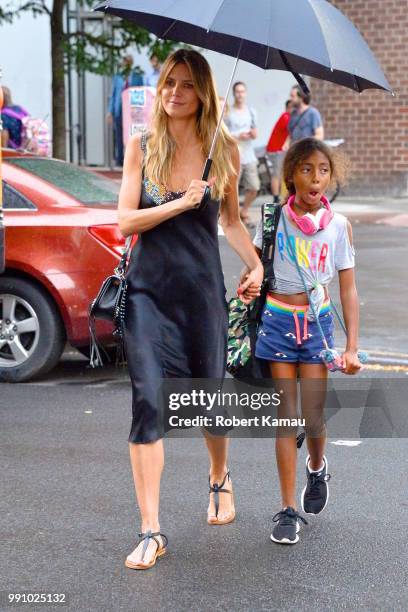 Heidi Klum and daughter Lou seen out on a rainy evening in Manhattan on July 3, 2018 in New York City.