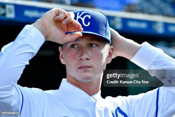 Right-handed pitcher Brady Singer, the Kansas City Royals' top pick of the 2018 draft, adjusts his hat after a news conference announcing his signing...