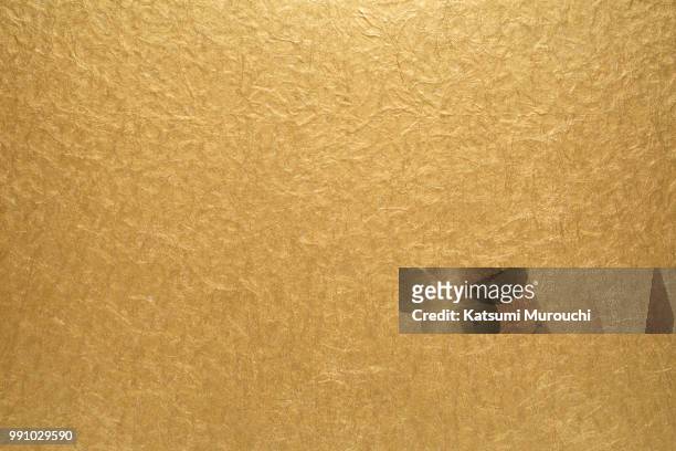 golden paper texture background - katsumi murouchi stock-fotos und bilder