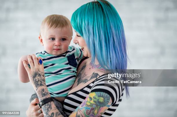 woman holding baby - little punk stock pictures, royalty-free photos & images