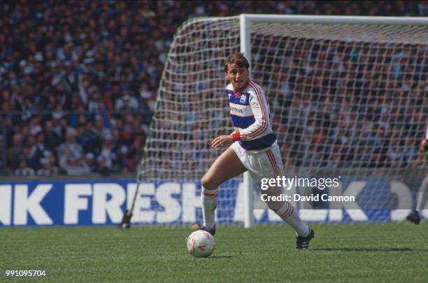 Irish footballer Michael Robinson on the ball for Queen's Park Rangers in the Football League Cup Final against Oxford United at Wembley Stadium,...