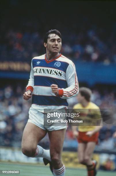 Irish footballer Michael Robinson on the ball for Queen's Park Rangers in a Football League First Division match against Watford FC at Loftus Road,...