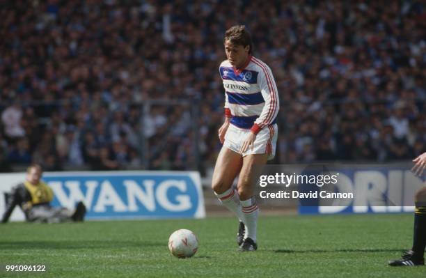 Irish footballer Michael Robinson on the ball for Queen's Park Rangers in the Football League Cup Final against Oxford United at Wembley Stadium,...