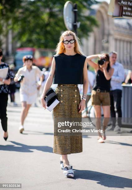 Ada Kokosar wearing cropped top, midi skirt is seen outside Chanel on day three during Paris Fashion Week Haute Couture FW18 on July 2, 2018 in...
