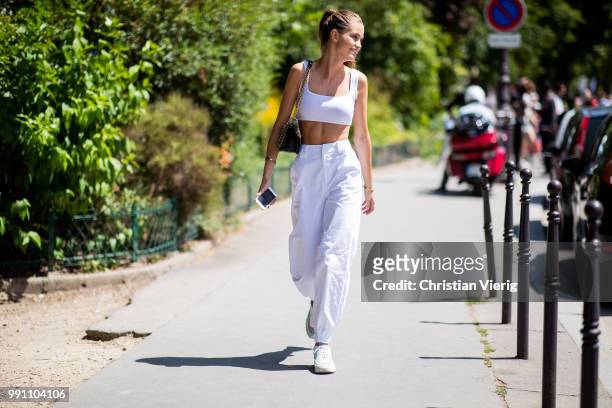 Model Luna Bijl wearing white cropped top is seen outside Chanel on day three during Paris Fashion Week Haute Couture FW18 on July 2, 2018 in Paris,...