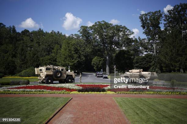 Mine-Resistant Ambush Protected armored vehicle, left, and a M1117 Armored Security Vehicle sit parked outside The Greenbrier resort ahead of a...