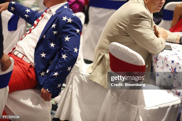 An attendee wearing American flag themed attire sits ahead of a Salute to Service dinner with U.S. President Donald Trump, not pictured, in White...