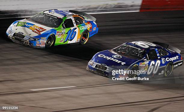 Carl Edwards, driver of the Copart Ford, races Matt Kenseth, driver of the Coupons.com, during the NASCAR Nationwide series Royal Purple 200...